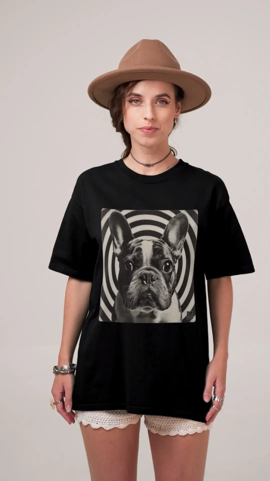 Woman wearing a minimalist French Bulldog t-shirt in a clean editorial fashion setting